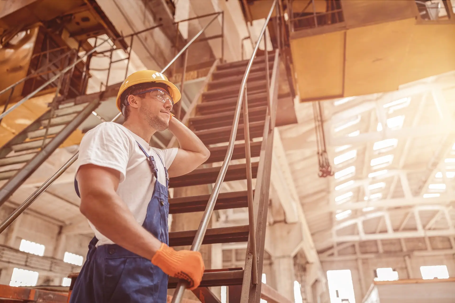 Male builder standing on stairs at construction site